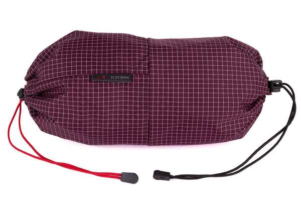 An Aeronaut 30 Travel Laundry Stuff Sack in Acai (dark purple with white grid) 200 Halcyon.
